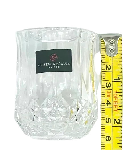 A clear shot glass from the Cristal D'Arques Eclat Collection, next to a measuring tape showing the glass's height.