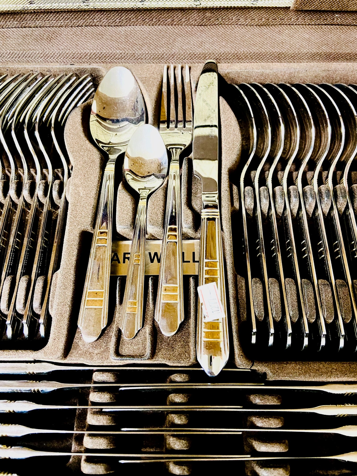 Set of silverware in a wooden box with 'Ware Wall' branding.