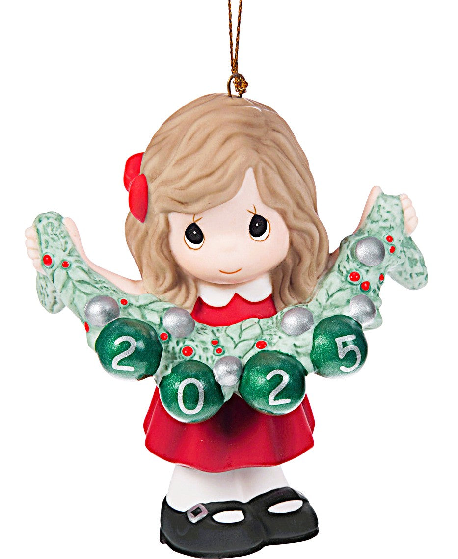 Christmas ornament of a girl holding a wreath with '2025' on a white background
