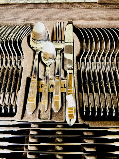 Set of silverware in a wooden box with 'Ware Wall' branding.