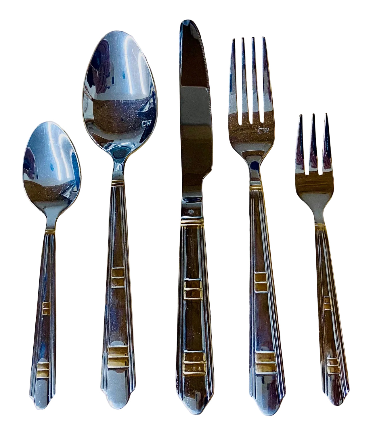 Set of silver cutlery including spoons and forks on a wooden surface
