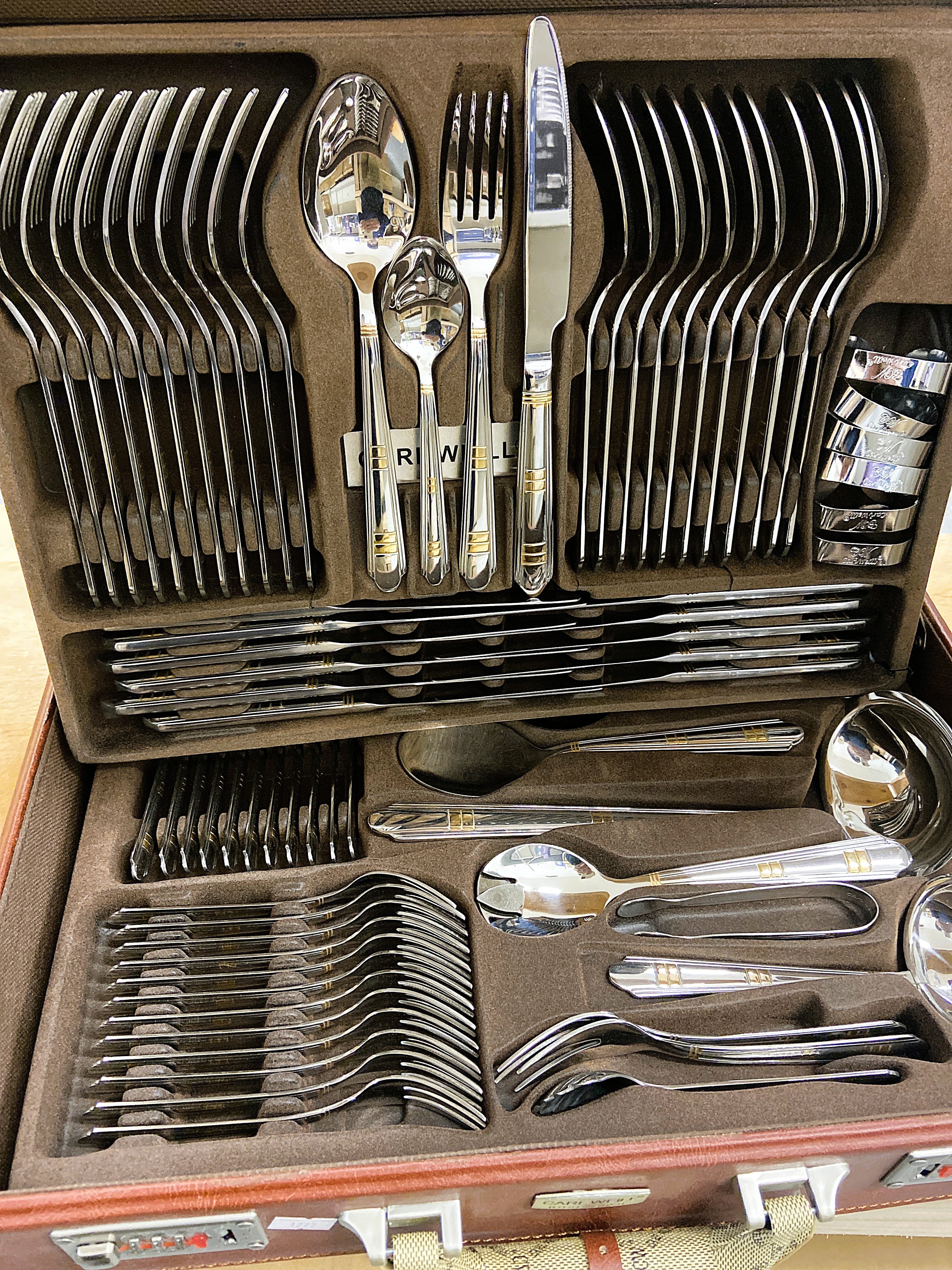 Set of silverware in a wooden case with 'RW' branding.